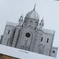 A black and white architectural art print of the Galway Cathedral, displayed on a rustic wooden surface.