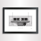A framed black and white architectural art print of the Mile End Tube station in London, featuring a detailed illustration of the building facade inside a black frame.