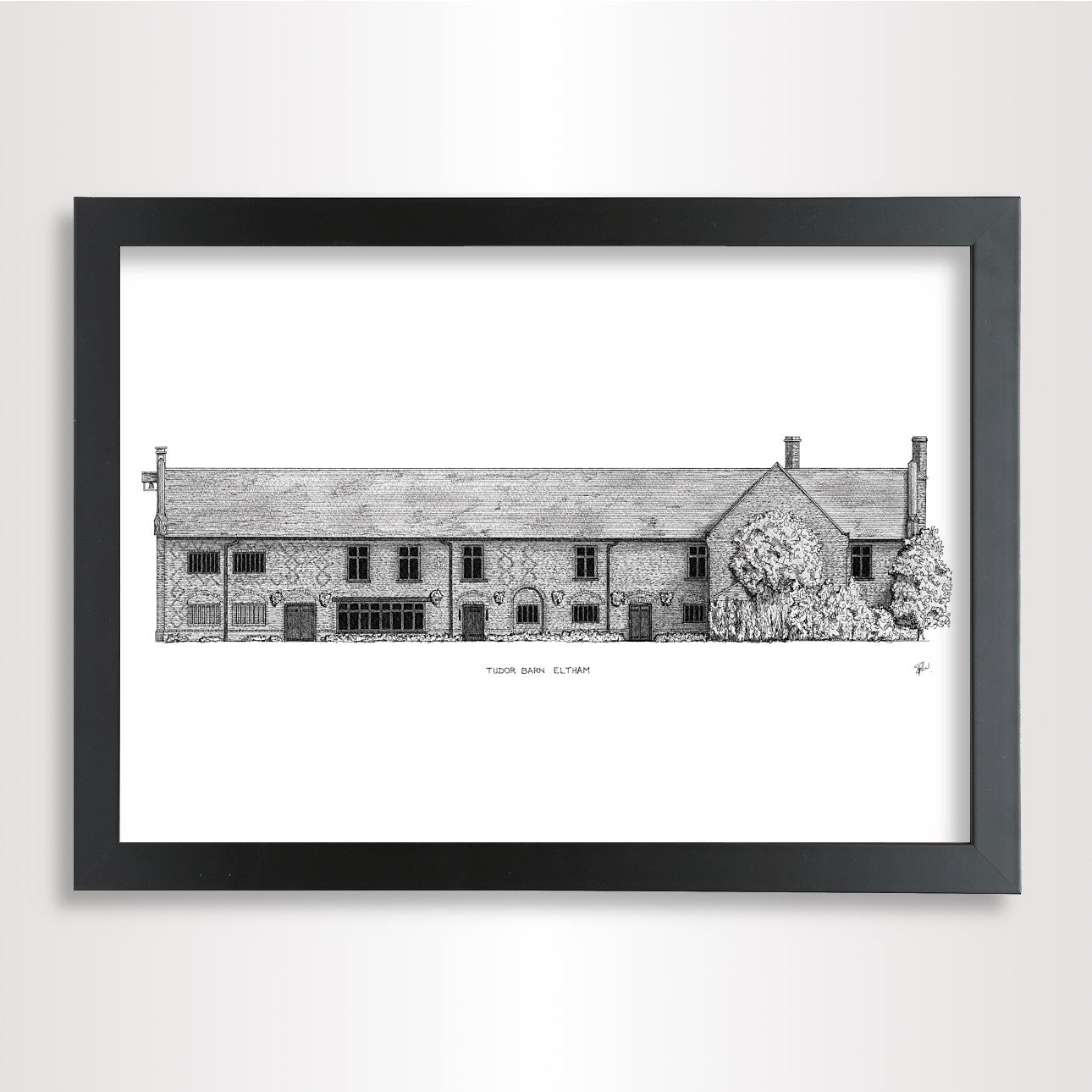 A framed black and white architectural print of 'Tudor Barn Eltham' on a white paper, enclosed in a black frame and shown against a light gray wall.